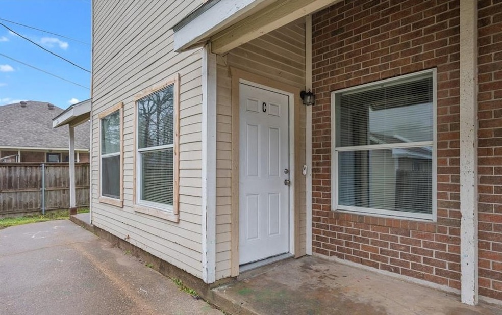 View of exterior entry featuring brick siding and