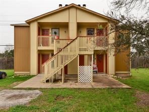 Rear view of property featuring covered porch, st