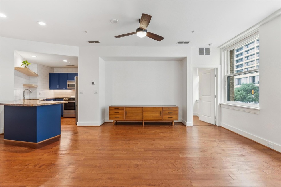 Unfurnished living room featuring ceiling fan, sin