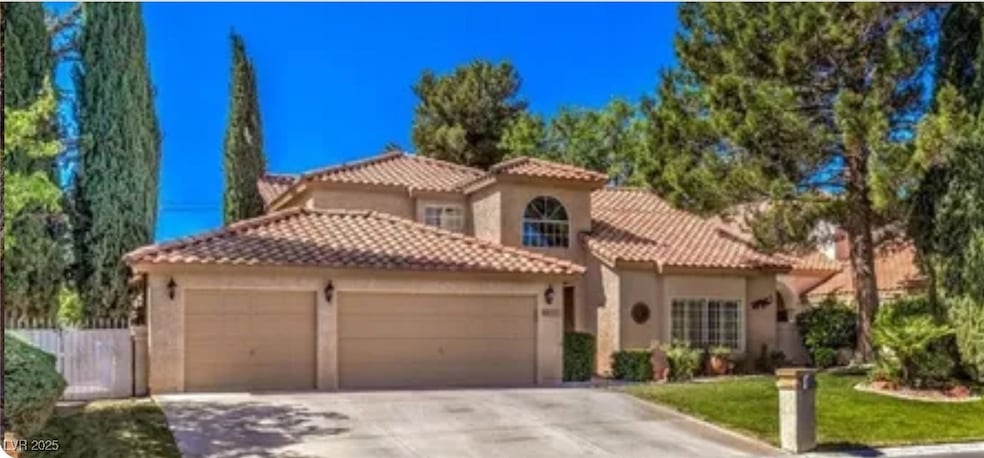 Mediterranean / spanish home with a garage, stucco siding, driveway, and a tile roof