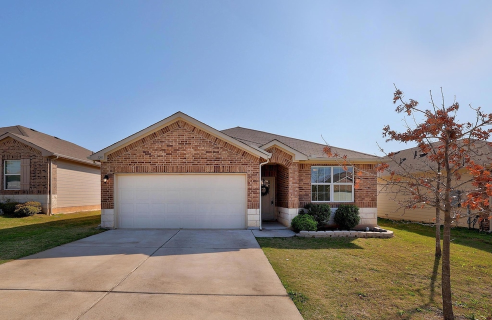 Single story home with an attached garage, concre