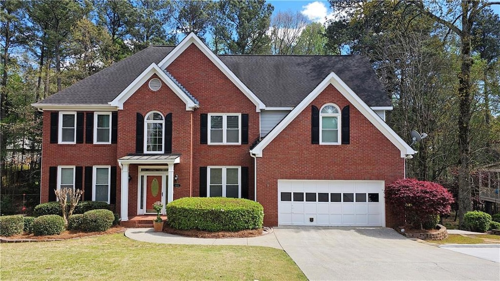 View of front facade with a garage and a front lawn