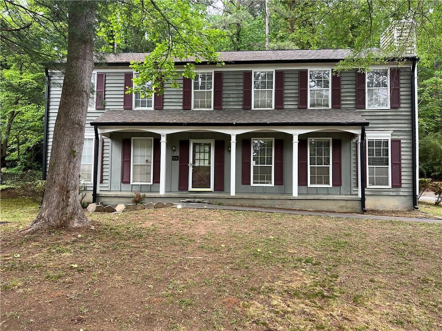 Colonial home with a porch and a chimney
