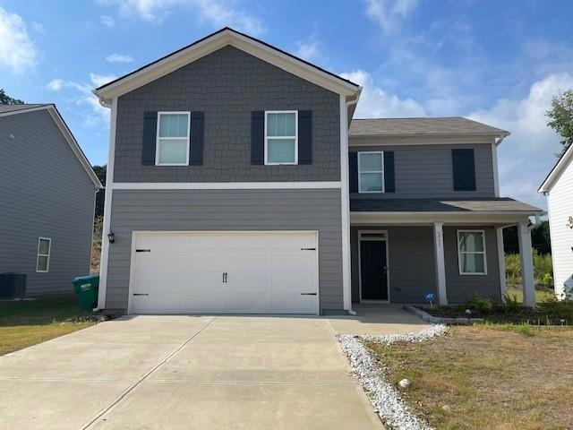 View of front facade with a garage and a front lawn
