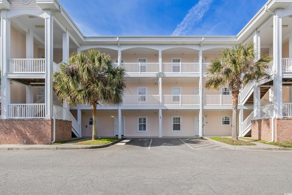 View of building exterior featuring uncovered parking