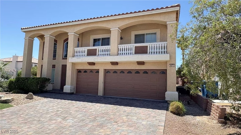 View of front of house featuring a garage, stucco