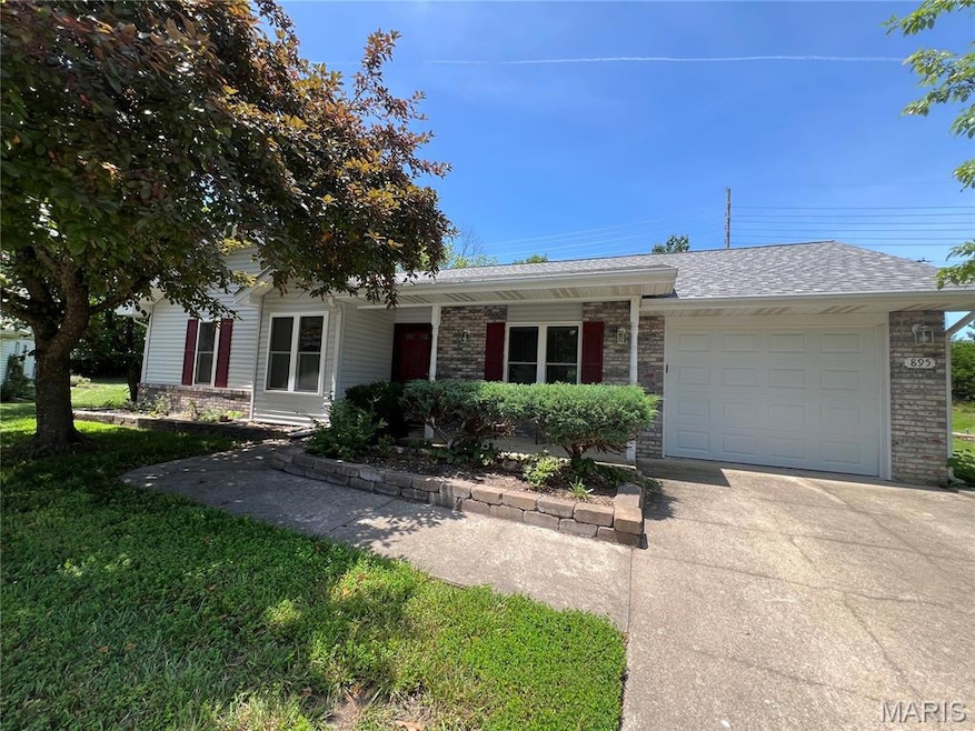 Ranch-style house featuring a porch, an attached garage, roof with shingles, concrete driveway, and brick siding