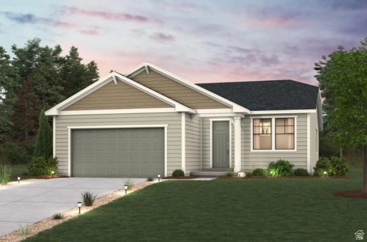 View of front of house with concrete driveway, a front lawn, and an attached garage
