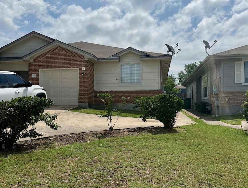 View of front of house featuring brick siding, an