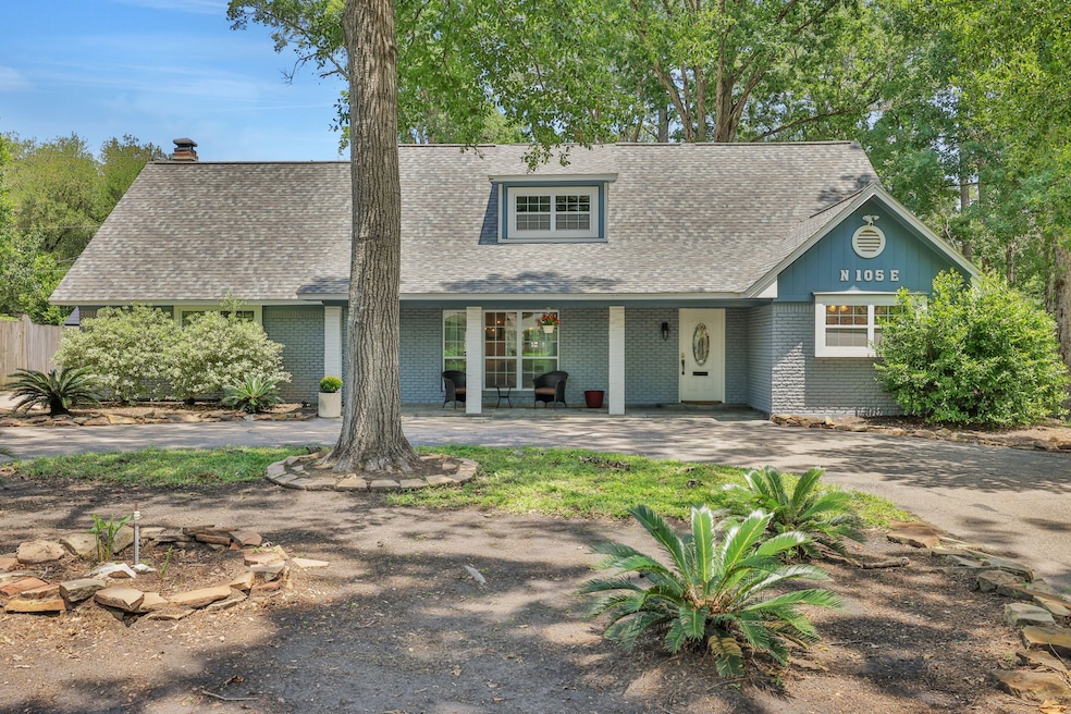 Inviting Front Exterior. Charming brick façade with mature trees and a circular driveway, offering timeless curb appeal.