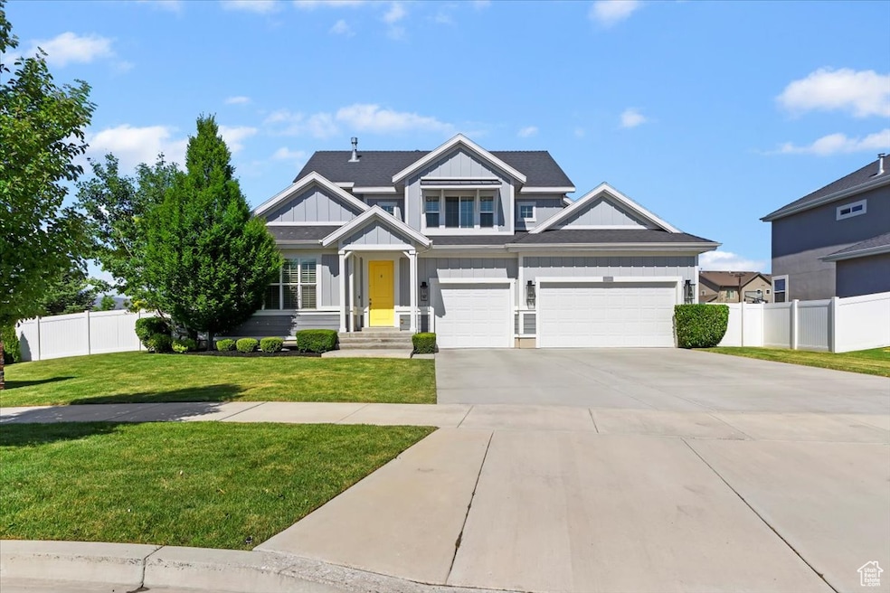 Craftsman-style house featuring board and batten siding, concrete driveway, and an attached garage