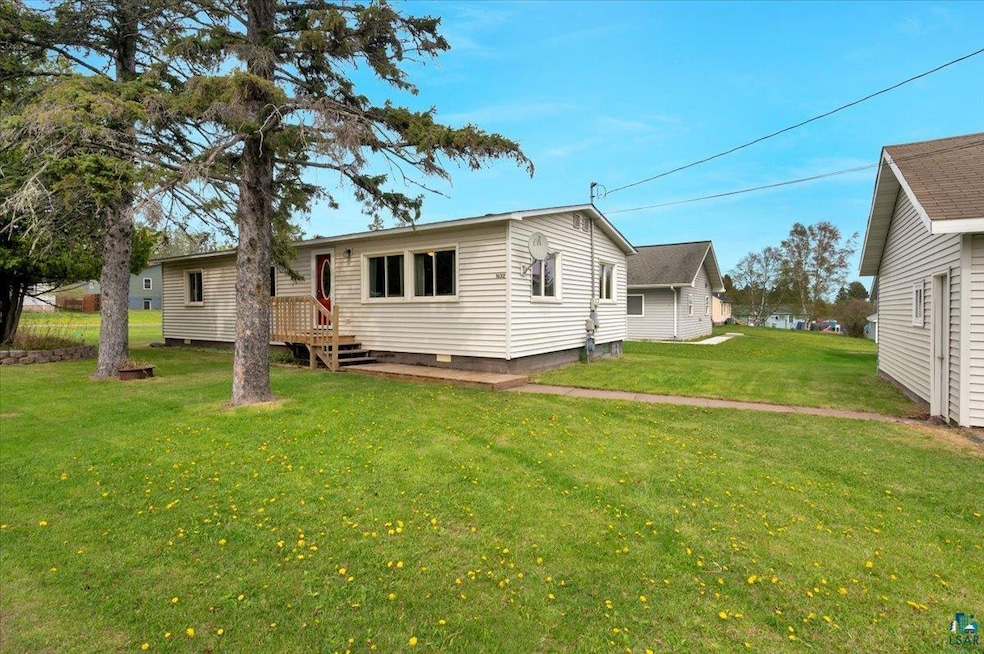 Rear view of house with a yard and crawl space