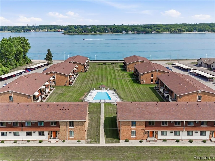 Bird's eye view of a nearby body of water and a pool area