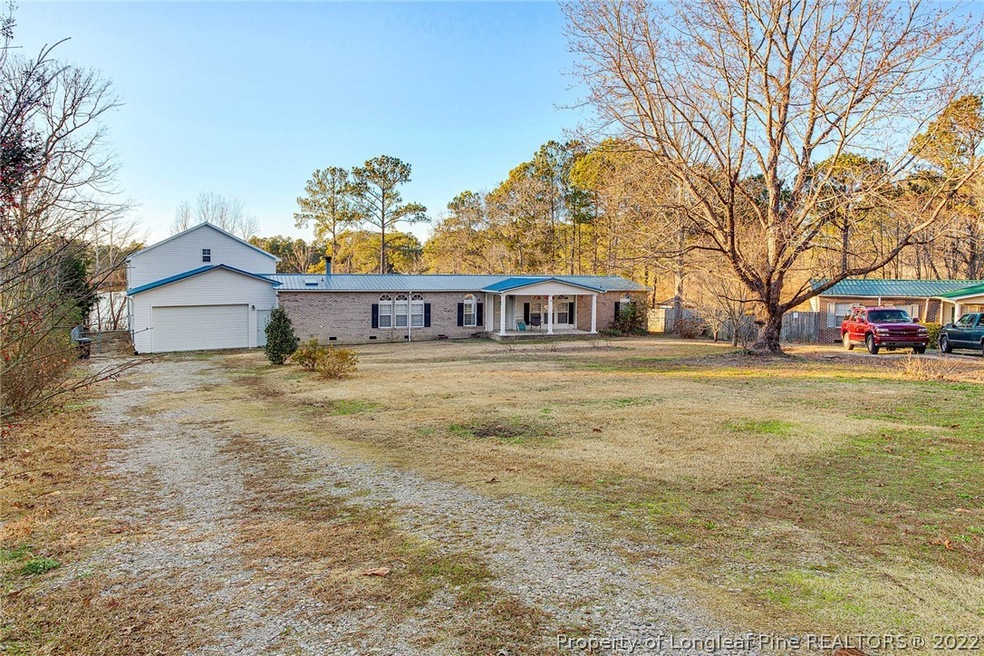 updated home with huge front yard and backyard with pond views with fishing dock!  Large garage add on with all of the storage you can imagine with opportunity to add another room!