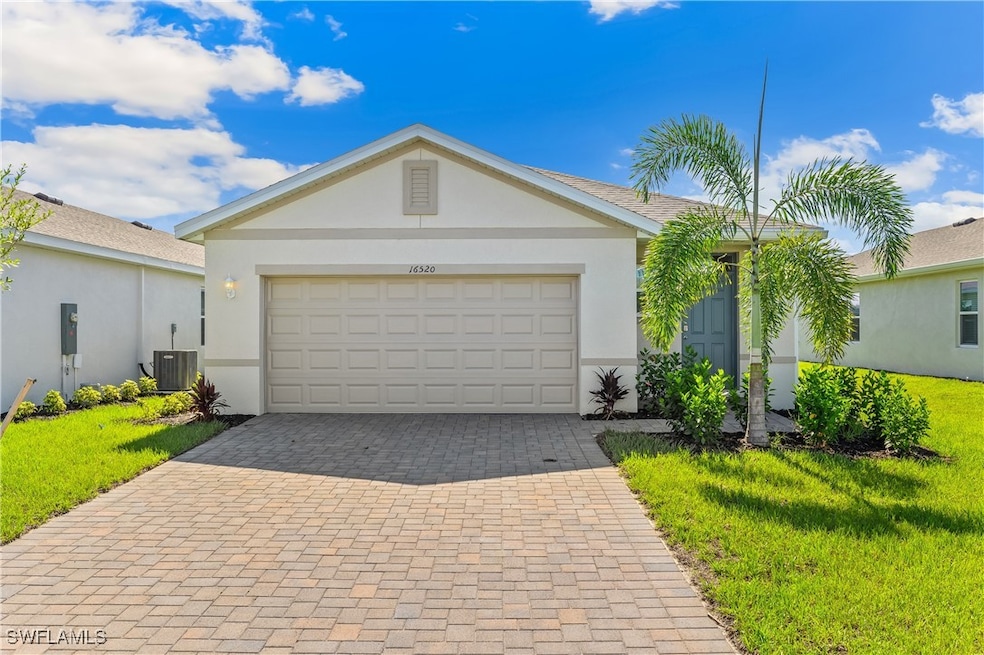 Single story home featuring decorative driveway, s