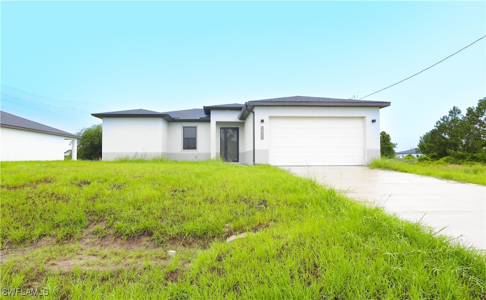 View of front of house with stucco siding, an atta