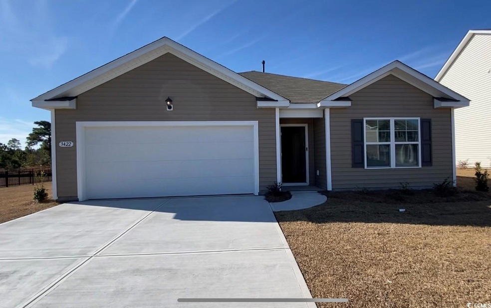 Ranch-style home featuring a garage and driveway