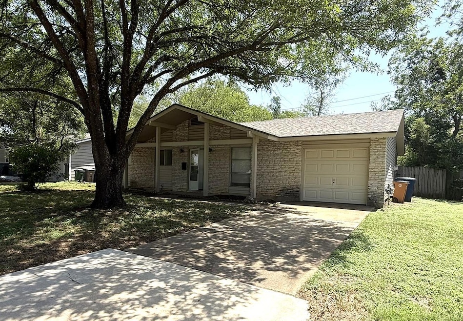 Single story home with a garage, driveway, and a 