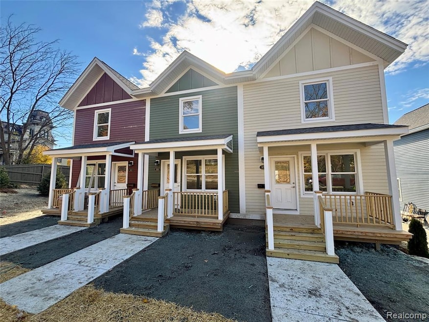 View of front facade with a porch and board and batten siding