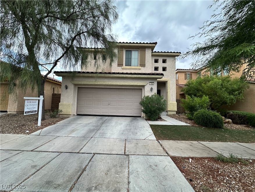 View of front of house with a tile roof, driveway,
