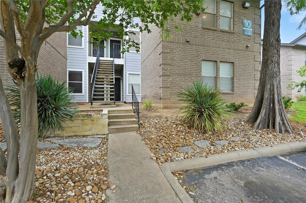 Doorway to property featuring brick siding