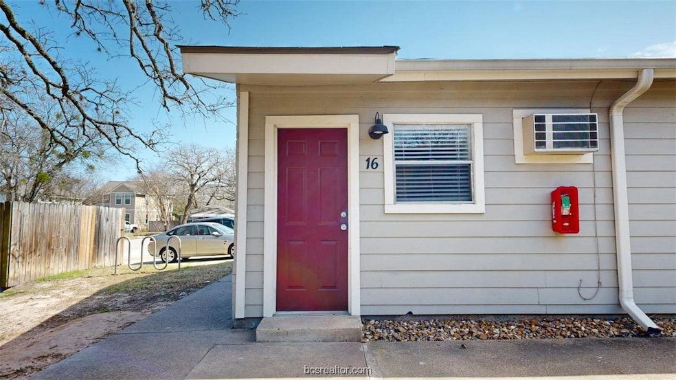 View of exterior entry featuring fence