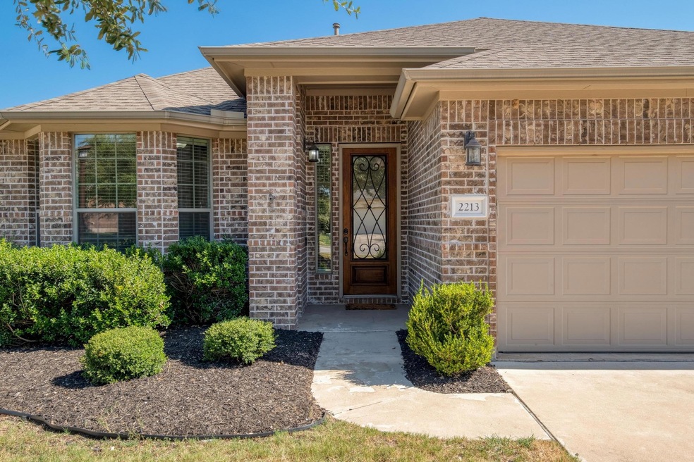 View of exterior entry featuring brick siding, ro