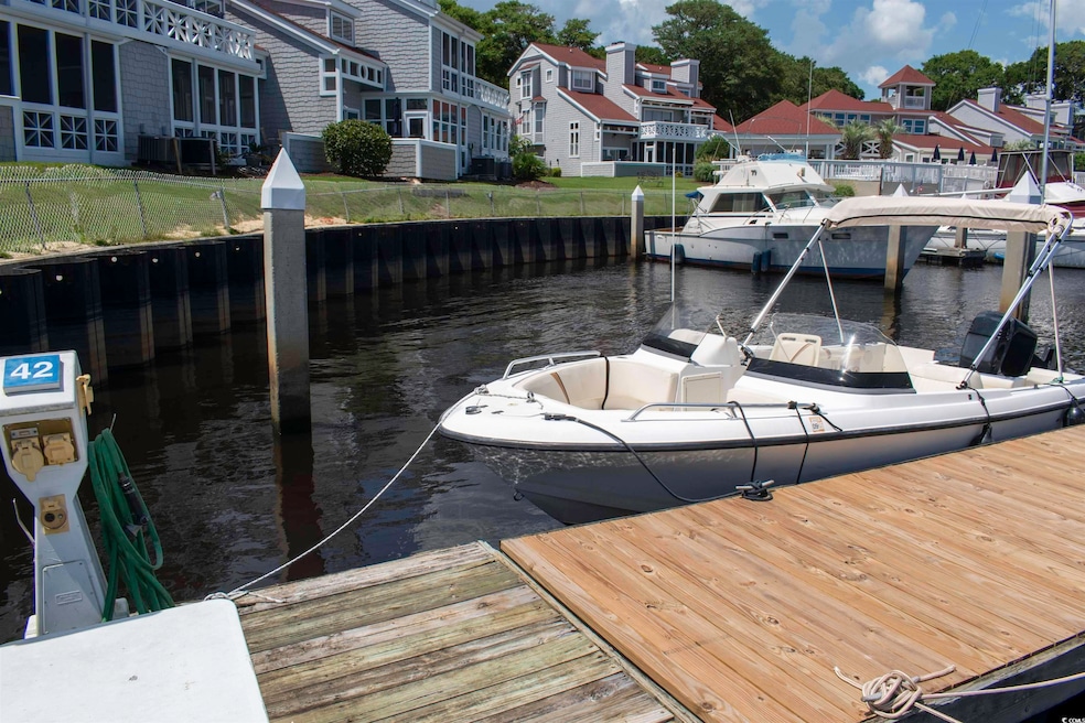 Dock area with a water view and a residential view
