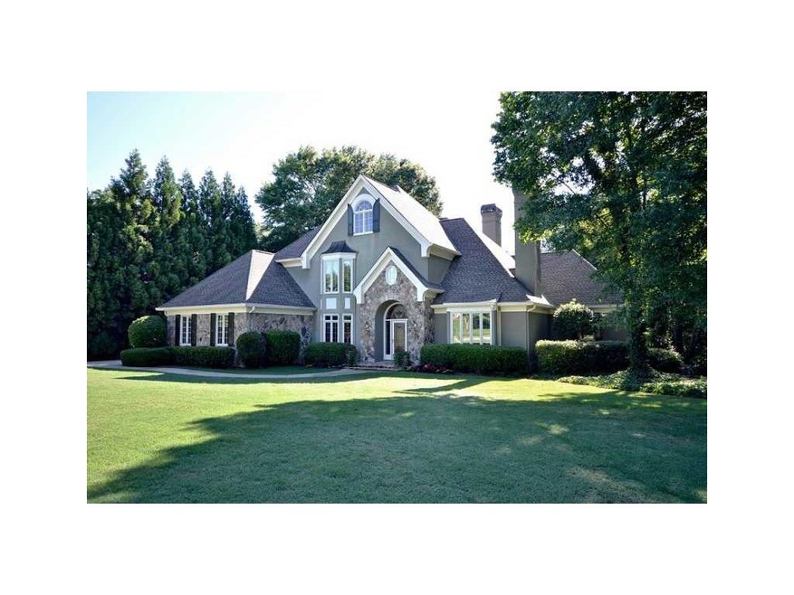 Exterior Front. Stone and hardcoat home offers cha