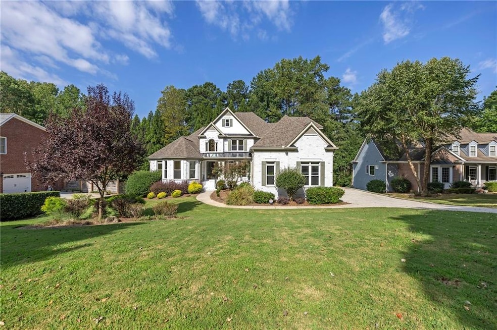 Traditional-style home featuring a front yard and driveway