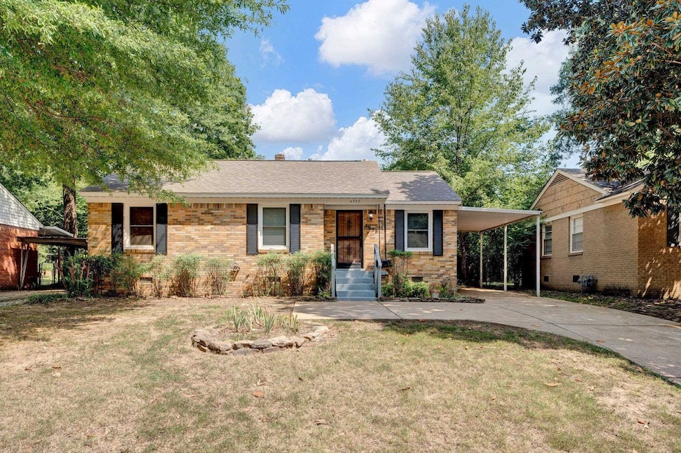 Ranch-style home with a front yard and a carport