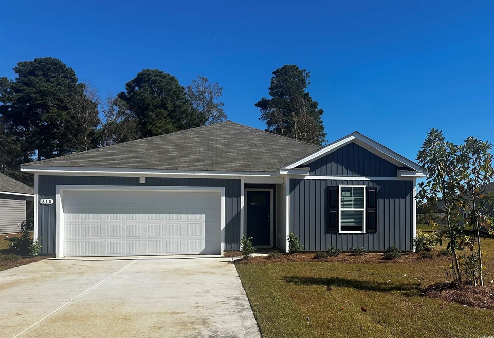 Ranch-style home with a garage and a front lawn