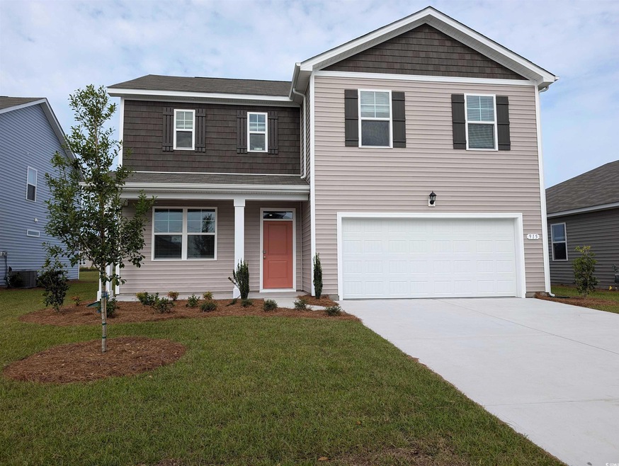 View of front of property with a garage, a front l