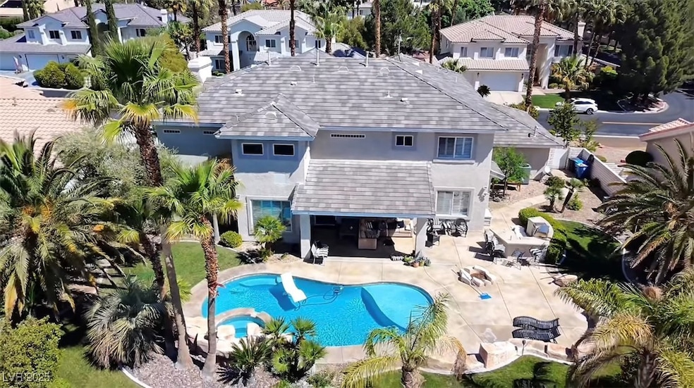 View of pool with a pool with connected hot tub, a patio area, and a residential view