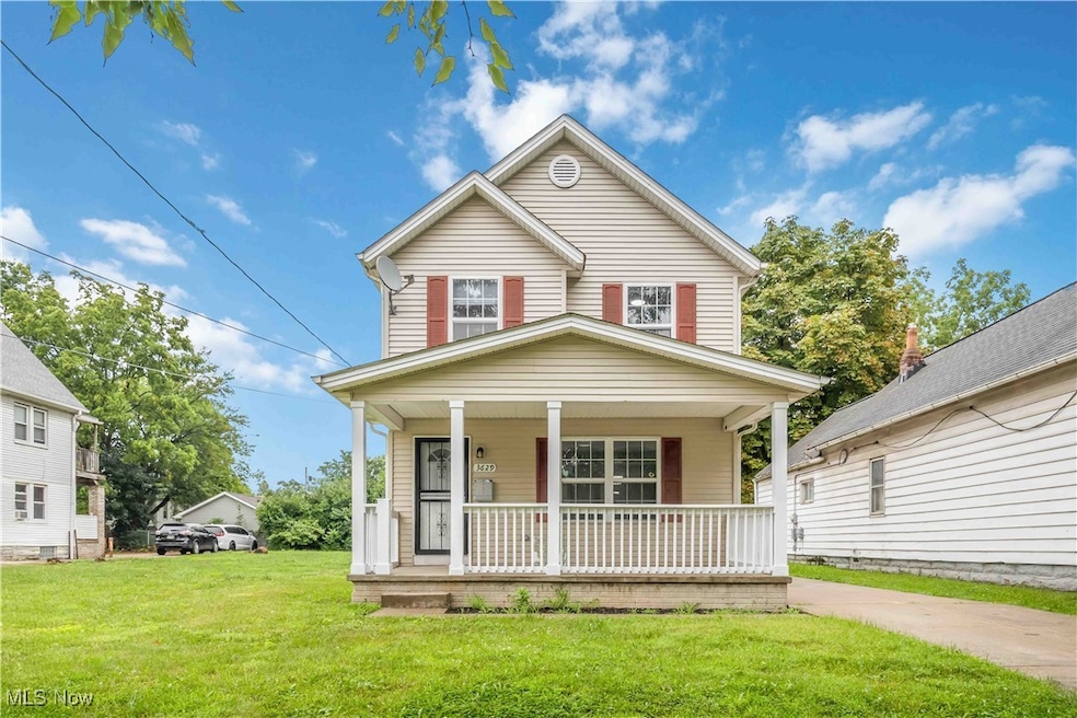 View of front of property with a porch and a front lawn