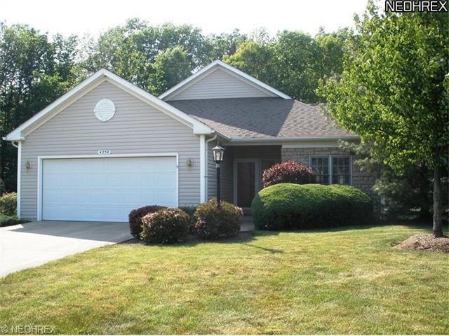 Situated on an expansive, private wooded lot, this