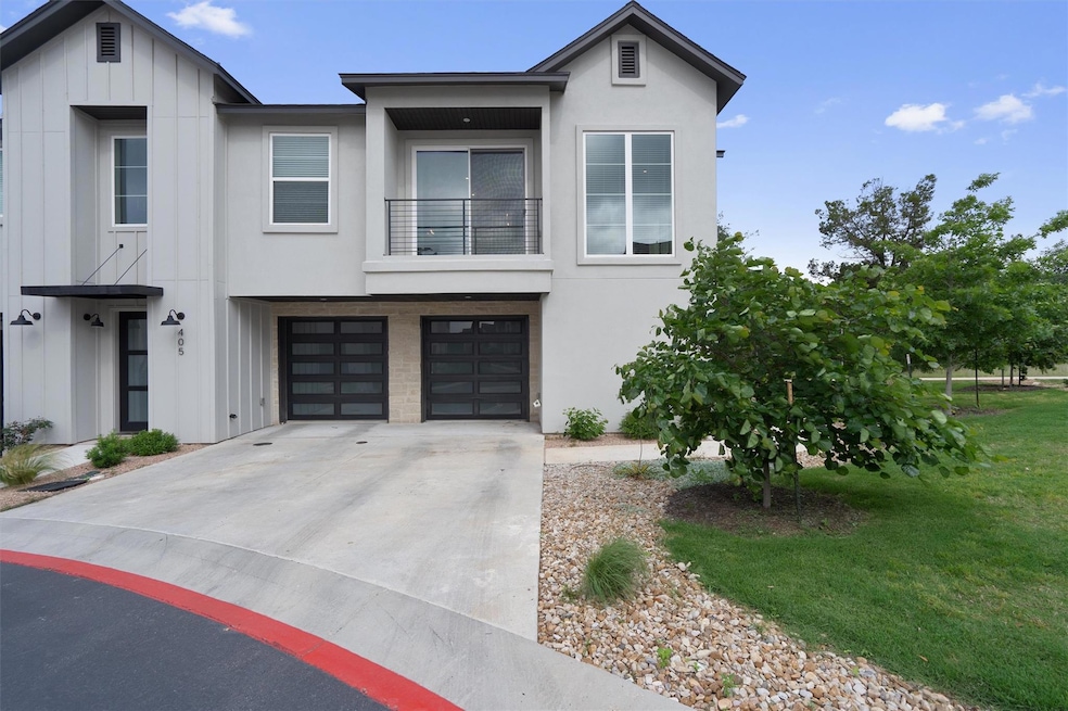 View of front of home featuring driveway, a balco