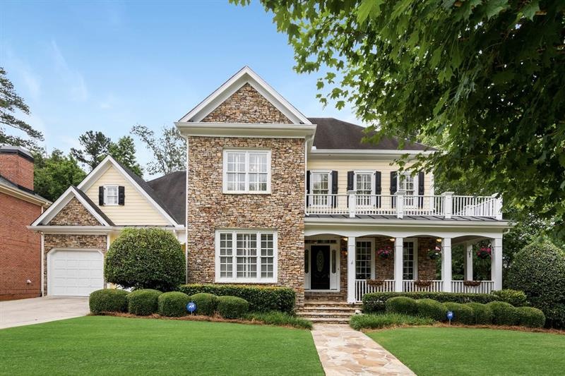 Gorgeous Craftsman Style home with wrap around covered front porch and three car garage.