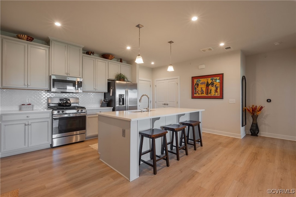 Kitchen featuring backsplash, hanging light fixtur