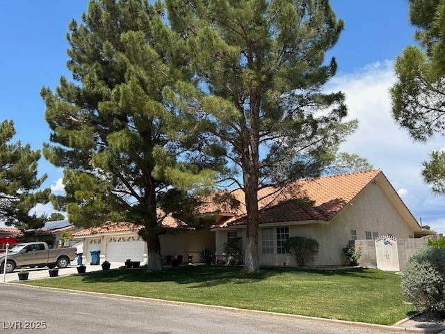 Ranch-style house with driveway, a garage, fence,