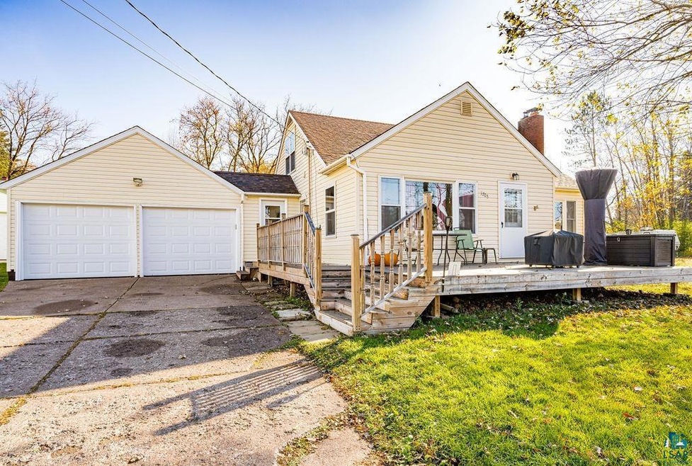 View of front of property featuring a wooden deck