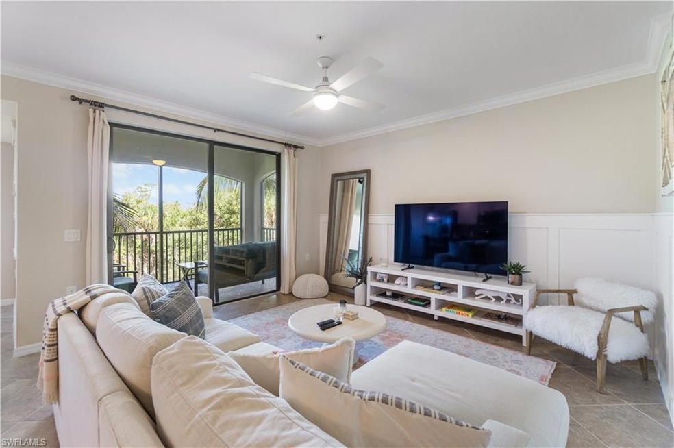 Living room with crown molding, ceiling fan, and l