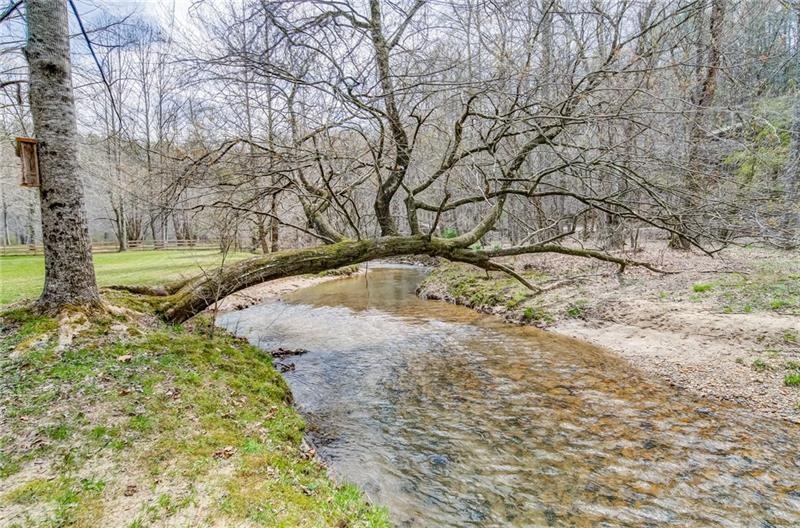 Wide rushing creek surrounding the property