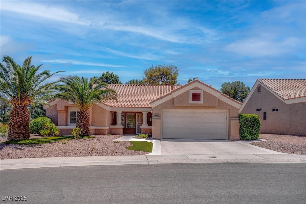 View of front facade featuring a garage, driveway,