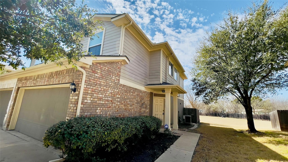 View of property exterior featuring a yard, brick