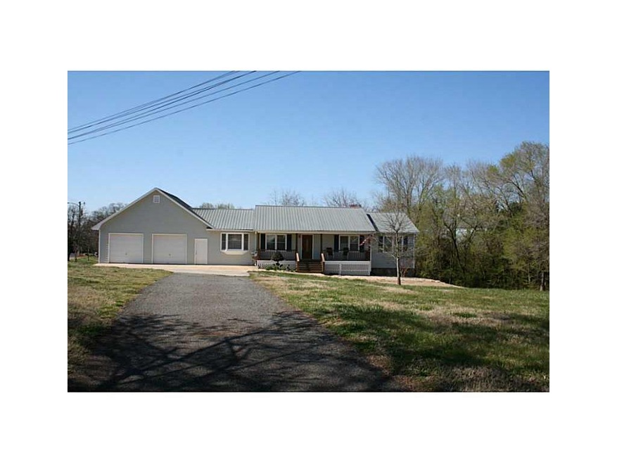 Exterior Front. Paved  driveway, big front yard wi