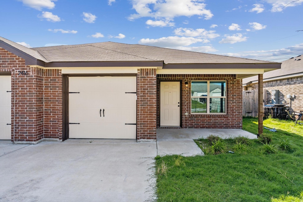 View of front of house featuring brick siding, a 