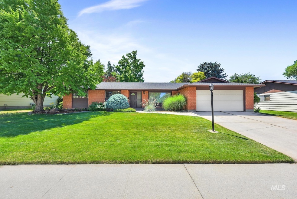 Ranch-style home featuring driveway, an attached garage, brick siding, and a front lawn