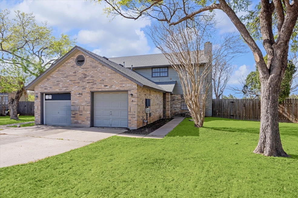 View of side of property featuring a chimney, bri