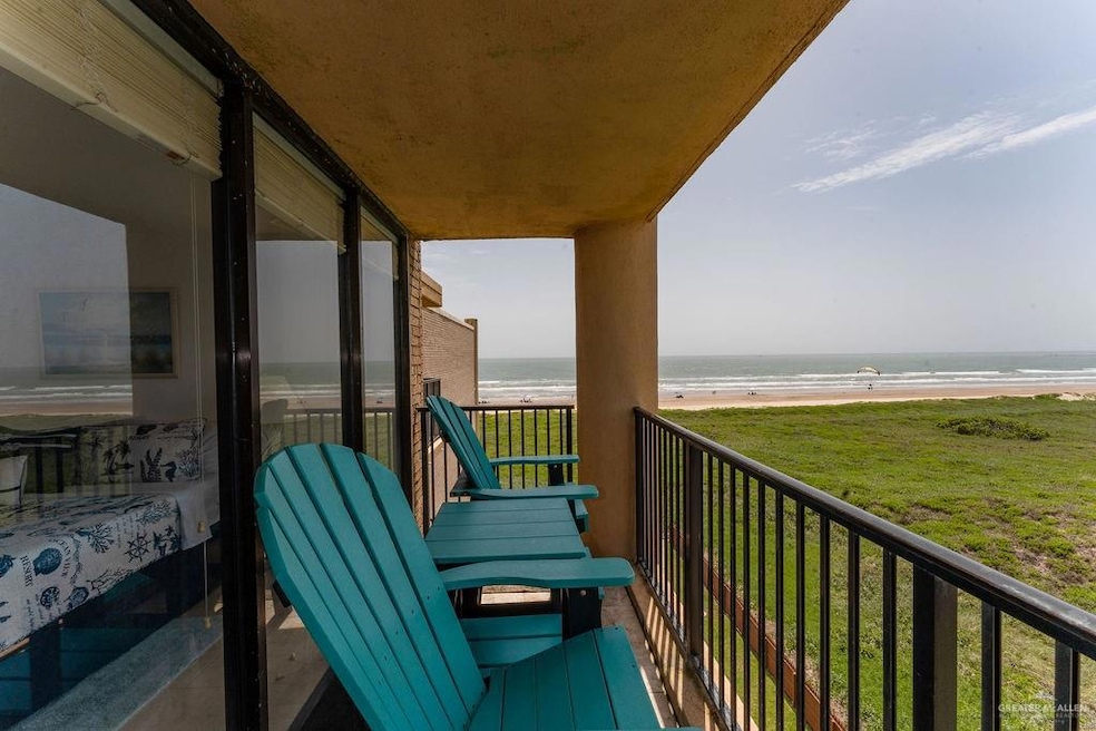 Birds eye view of property with a beach view and a water view